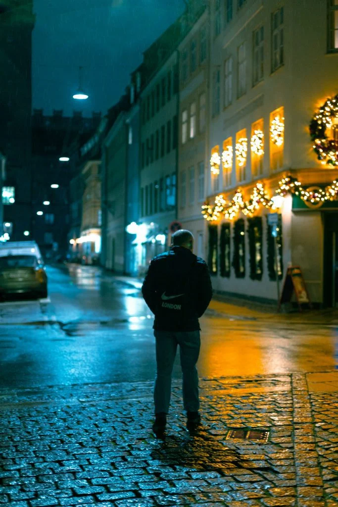 Guy alone on a festive street in the dark. Loneliness as a holiday porn trigger is real.